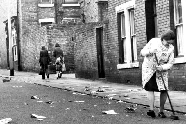 A woman does her bit for Keep Britain Tidy Week in 1974 by sweeping the street in Barnes Road, Sunderland.
