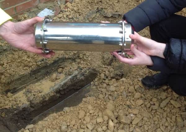 New Seaham Academy pupils bury a time capsule with help from Malcolm Hedley of Brims Construction.