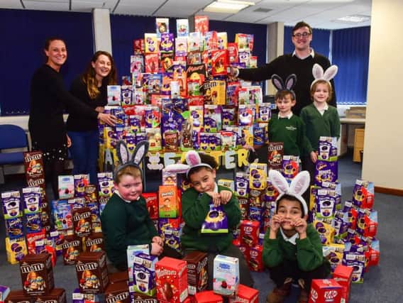 Deputy Leader of Sunderland City Council and Vice-Chair of Governors at Hudson Road Primary, Councillor Michael Mordey, with (back from left)  Sunderland City Council Business Support Operational Manager, Paula Walker, Sunderland foodbank network co-ordinator, Kate Townsend, and (front) Year 2 pupils from Hudson Road Primary School helping to arrange the donated Easter Eggs for distribution to families across the city
