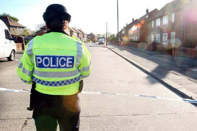 A police officer stands on guard at the scene of Kevin Johnson's murder in Pennywell in 2007.