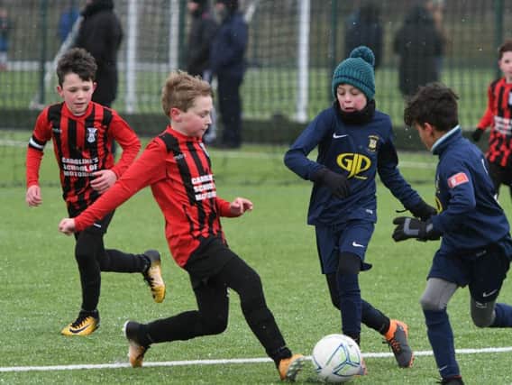 Humbledon GJP, wearing blue, in under 10s action against Consett AFC Seahawks, in red, at Silksworth Sports Complex.