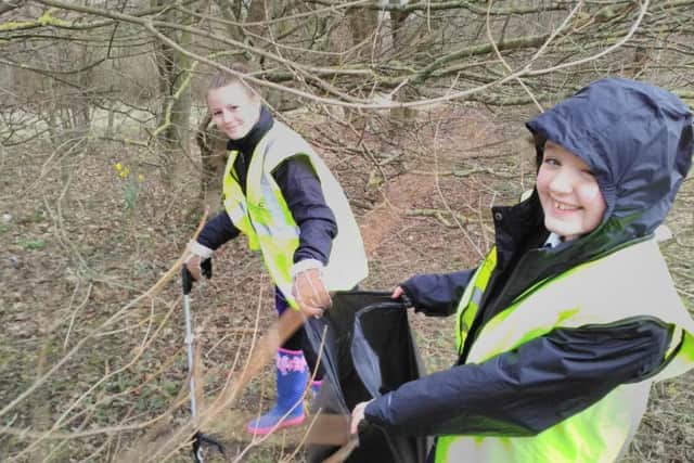 Kiera Marshall and Lily McCann, both 11, from Castle View Enterprise Academy taking part in a litter pick, one of the various voluntary projects taking place around the castle grounds while restoration work continues
