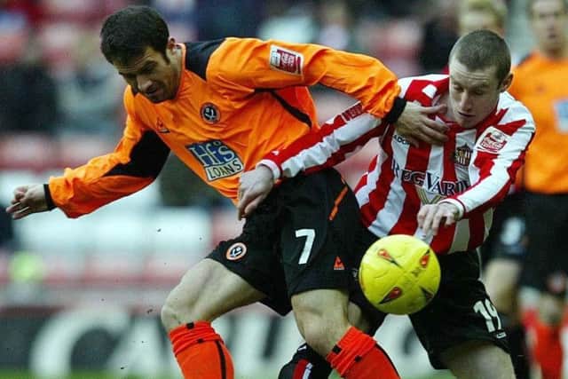 Former Sunderland striker Stephen Elliott battles for the ball.