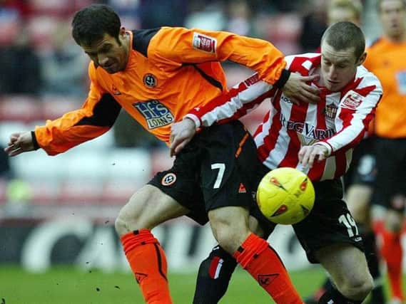 Former Sunderland striker Stephen Elliott battles for the ball.