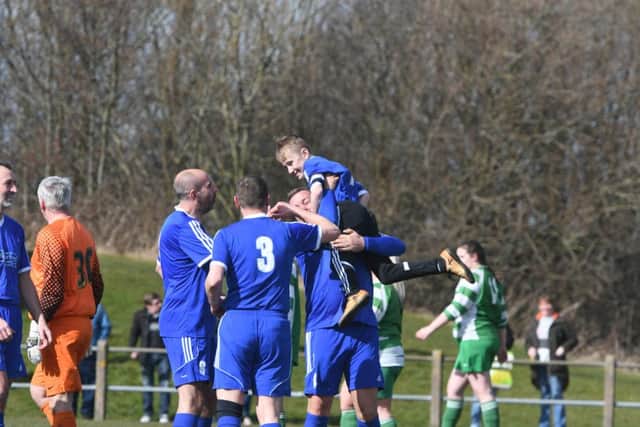 Daniel is held aloft after scoring a goal in the match.