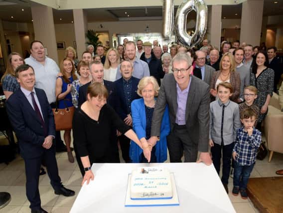 Professor Ruth Plummer, Lady Elsie and Mark Robson cutting a cake surrounded supporters of the Sir Bobby Robson Foundation supporters, at a 10th anniversary celebration of the charity being set up in Newcastle.