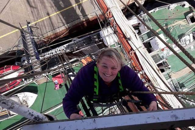 Jade is all smiles as she overcomes her fears to climb the mast of the Stavros S Niarchos.