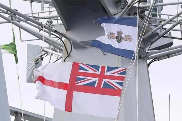 The Ensign is lowered at the decommissioning ceremony for Sunderland's adopted warship, HMS Ocean. Pic: PA.