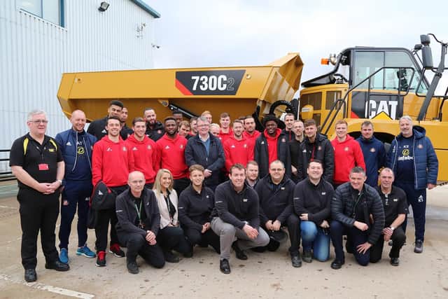 Members of the Sunderland AFC squad with employees at Caterpillar.