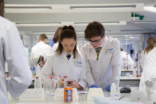 Students work on testing cans of Irn Bru during the laboratory day.