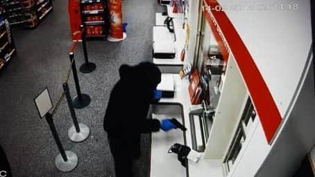 David Parkin brandishes a gun during the robbery on February 14.