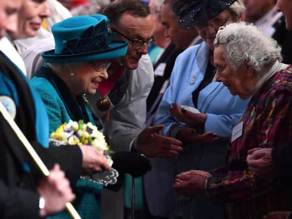 Her Majesty hands out Maundy Money at last year's service