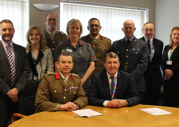 South Tyneside NHS Foundation Trust Chief Executive Ken Bremner at the signing of the Armed Forces Covenant, alongside Deputy Commander 4 Infantry Brigade Colonel Andrew Hadfield, with Trust Board members and reservists and Ministry of Defence representatives