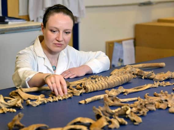 Dr Anwen Caffell of Durham University examines the remains of one of the Scottish soldiers who were taken prisoner at the Battle of Dunbar in 1650.