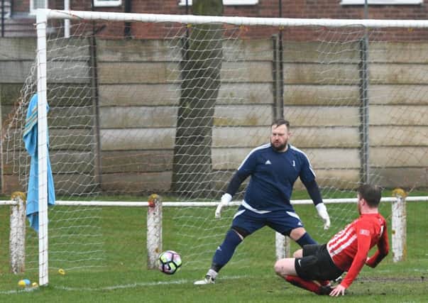James Cook touches home Silksworth CW's opening goal against Hebburn Town Reserves on Saturday. Picture by Kevin Brady