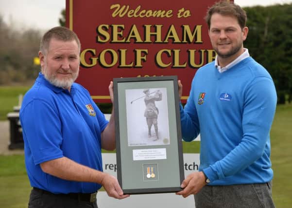 Paul Murray and club captain Grant Dixon with a photo of Private Michael Moran playing.