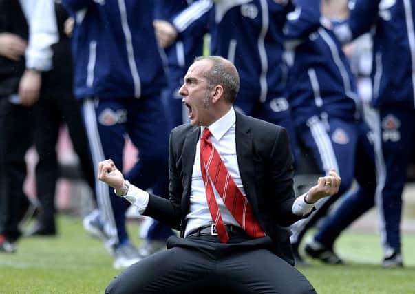 New Sunderland boss Paolo di Canio sinks to the St James's Park turf in celebration.