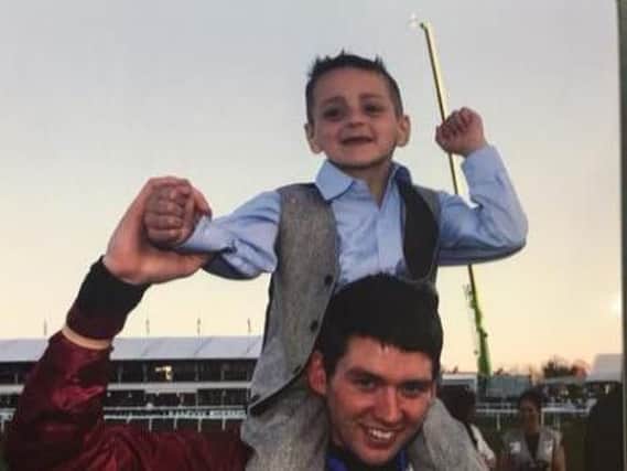 Derek Fox, who rode One For Arthur to victory at last year's Grand National, pictured with Bradley Lowery on his shoulders following his win.