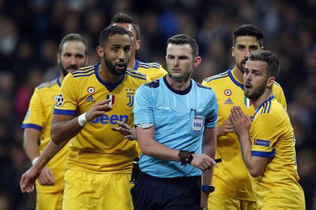 Michael Oliver is surrounded by Juventus players after awarding a penalty to Real Madrid in the Champions League. Photo: AP.