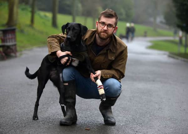 Dog owner Ben Favaro with dog Juno is angry over smashed glass in Barnes Park