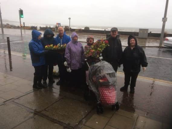 The planting took place despite adverse weather conditions.