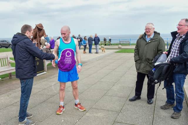 Scott Baker is welcomed by his brother Peter and family and friends at the halfway mark of his 1000th 10K run on consecutive days,  at the Tommy statue, Seaham on Saturday.