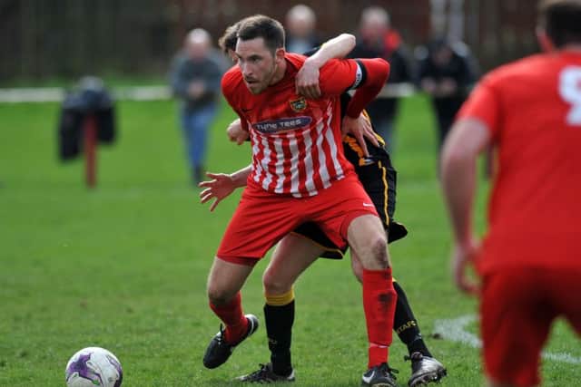 Chris Trewick of Ryhope CW (red) scraps against Morpeth Town last week. Picture by Tim Richardson