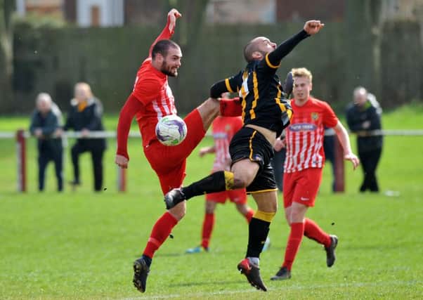 Ryhope CW's Josh Home-Jackson (red) scraps against Morpeth Town in the First Division last week. Picture by Tim Richardson