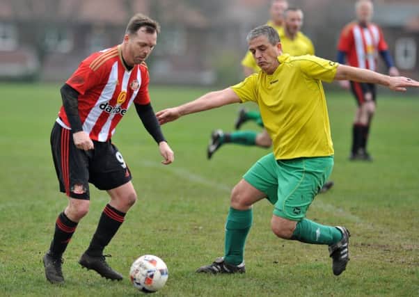 Over-40s action  between Mill View SC (red/white) and Darsley Park at Thompson Park last week. Picture by Tim Richardson