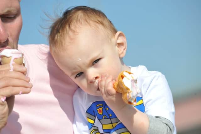 Two year old Jax Kelly enjoys an ice cream with dad Ryan.
