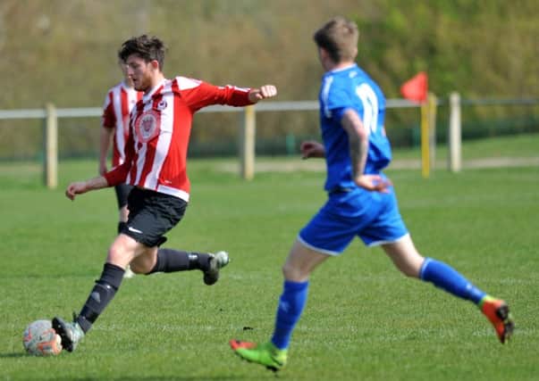 Sunderland West End (red/white) line up a shot in Saturday's win over Stokesley. Picture by Tim Richardson.