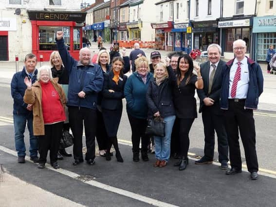 Retailers celebrate the removal of blue barriers which segregated Byron Place Shopping Centre and independent retailers on Church Street, Seaham.