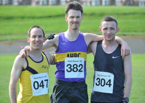 Kurt Herron (centre) enjoys his Sand Dancer 10k race victory with runner-up Andy Burn (left) and third-placed Liam Taylor. Picture by Tim Richardson.