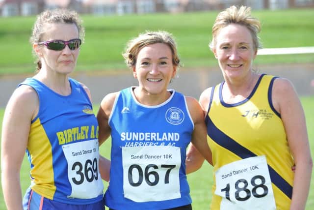 Vikki Cotton (centre) celebrates her Sand Dancer 10k race success with runner-up Ruth Dadswell (left)  and third-placed Elaine Leslie. Picture by Tim Richardson