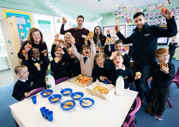 Staff and students at Thorney Close Primary School with Magic Breakfast's Tom Halliley and Amazon managers Alison Burns and Craig Watson.