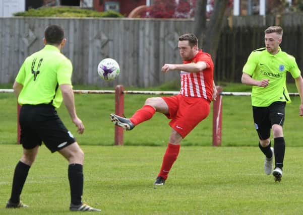 James Ellis takes control for Ryhope CW (red/white) in last week's win over Bishop Auckland. Picture by Kevin Brady