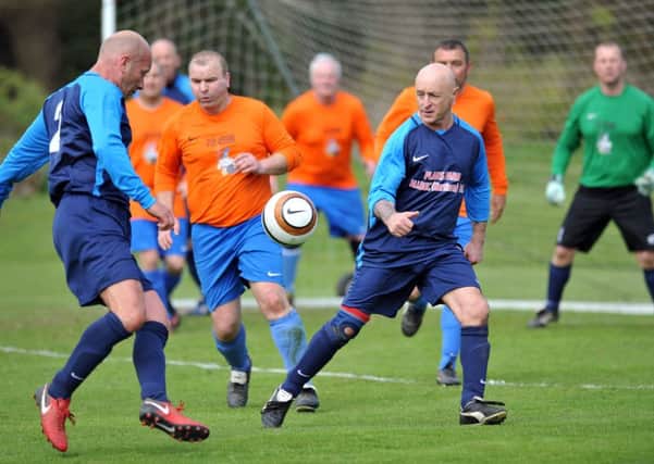 Ironside Cup Final action as Plains Farm Alldec Over-40s (blue) take on South Shields Catholic Club. Picture by Tim Richardson.