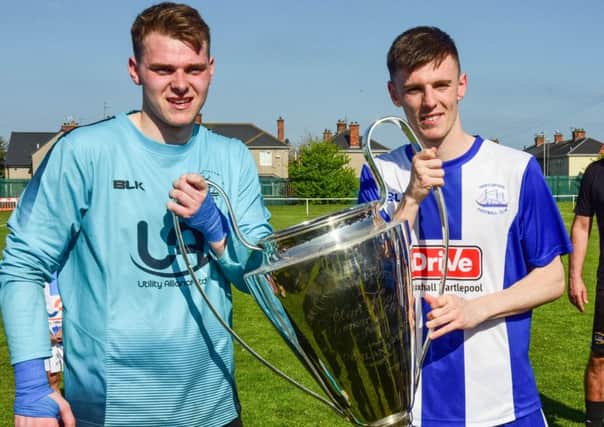Hartlepool goalkeeper Elliot Coils and winning penalty taker Mike Snowdon celebrate lifting the Alan Hood Memorial Trophy.