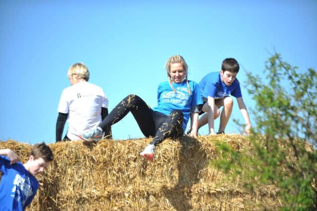 Participants in the Sunderland Scramble 5k event at Herrington Country Park tackling one of the 11 obstacles.