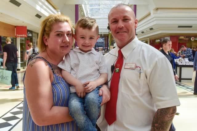 Jayden and mum Sarah Gray thank security guard Carl Simpson for saving the boy from choking.