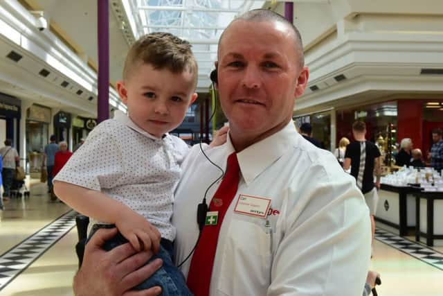 Jayden Percy with security guard Carl Simpson, who saved him from choking.