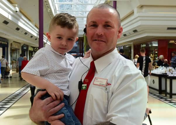 Jayden Percy with security guard Carl Simpson, who saved him from choking.
