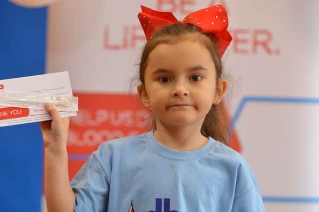 Chloe Gray with one of the DKMS swab kits used to find stem cell donors