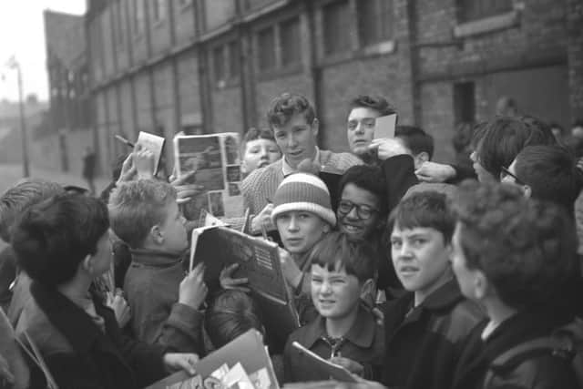 Jimmy Montgomery signs autographs for young supporters outside Roker Park.