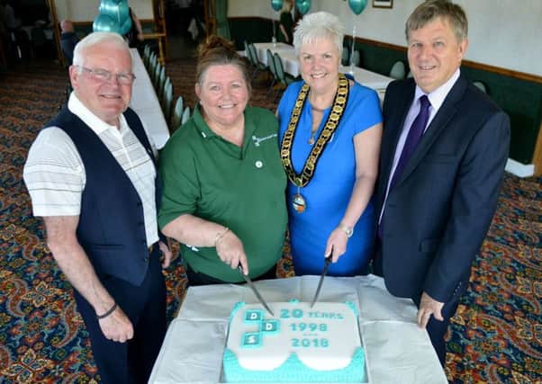 Cake cutting time at the 20th anniversary party of the Durham Deafened Support group (left to right) Alex and Jane Atkinson (group members) Isabel Roberts (chair of Horden Parish Council) and Dr. David Blackwell (chair of the group management board). Picture by Frank Reid