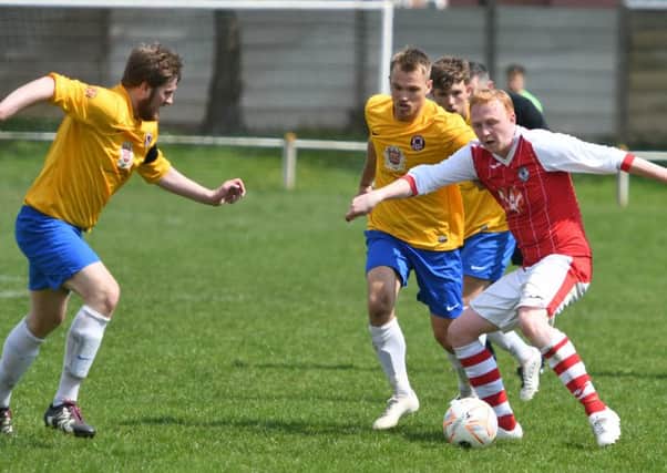 Sunderland West End (yellow) battle against Silksworth CW in Monday's TWR Shipowners Charity Cup final win.