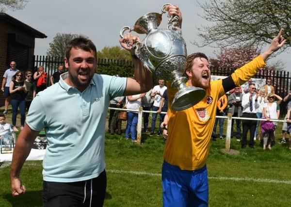 Nathan Cummings (left) and Lee Smith hoist the Shipowners' Cup after Sunderland West End's 2-0 final win over neighbours Silksworth CW. Picture by Kevin Brady