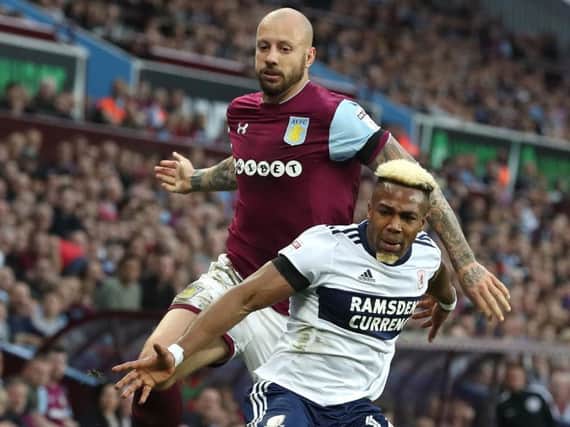 Alan Hutton and Adama Traore battle for the ball.