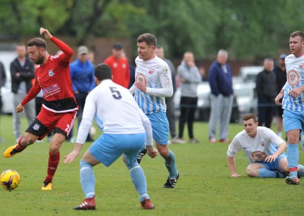Southwick (red) attack against Victoria Gardens in last week's Premier Division title decider. Picture by Tim Richardson