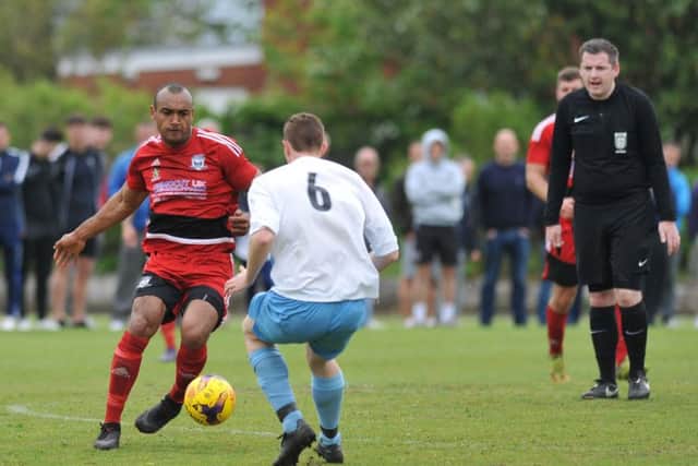 Southwick's Ash Davis (red) sets up an attack against Victoria Gardens. Picture by Tim Richardson